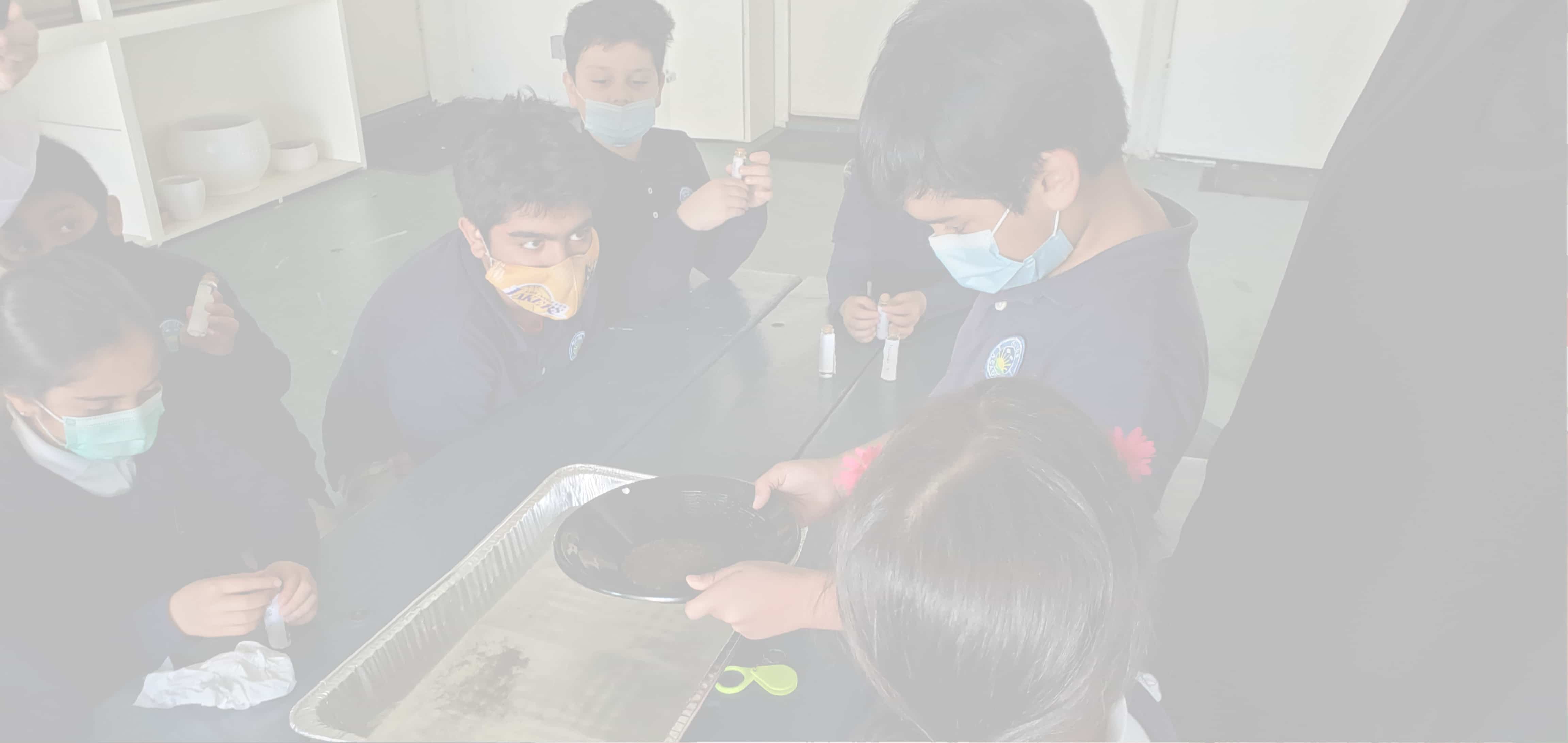 Child practicing pouring in Montessori practical life lesson