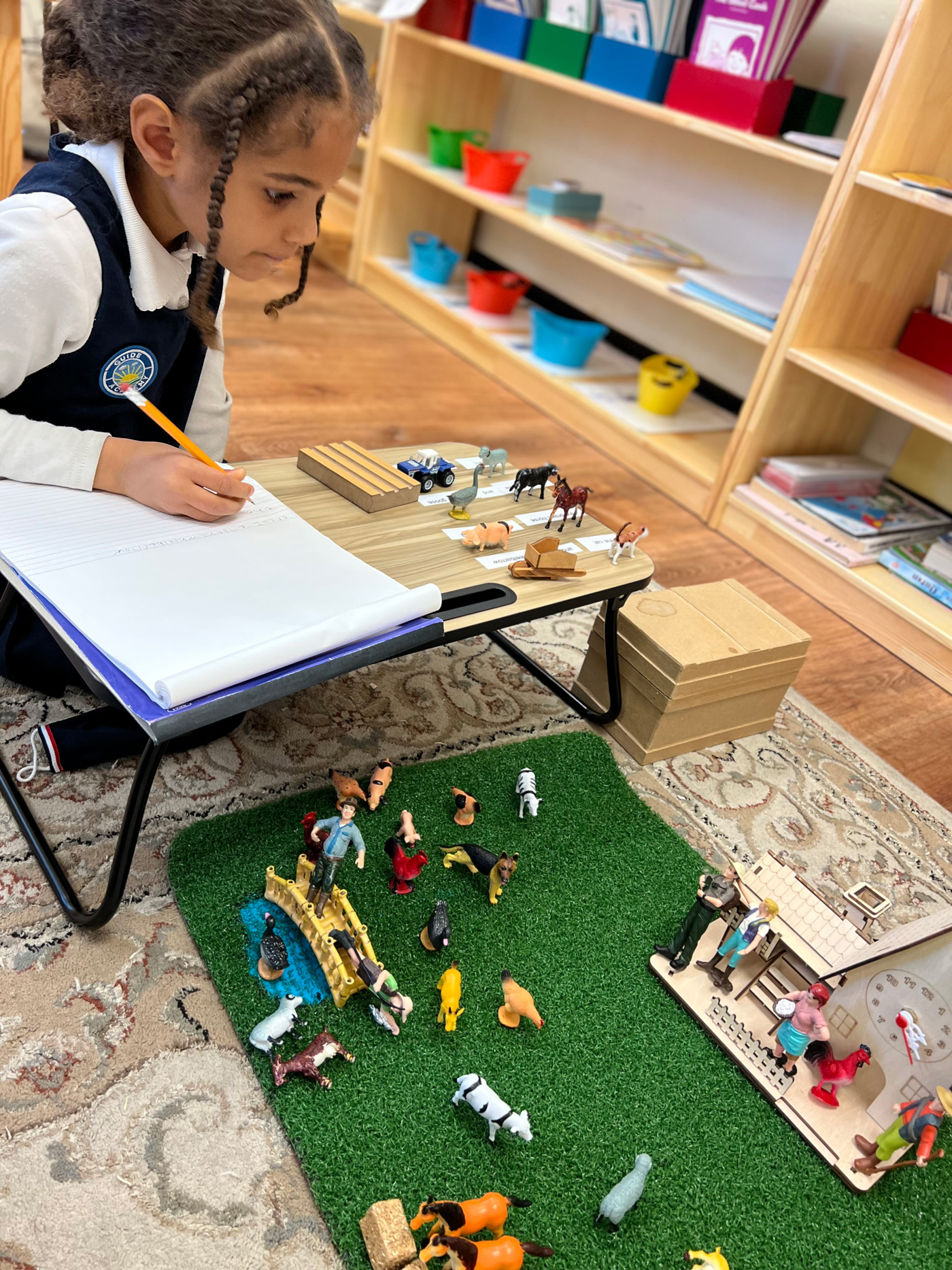 A creative student is writing in the Montessori class