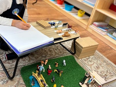 A creative student is writing in the Montessori class